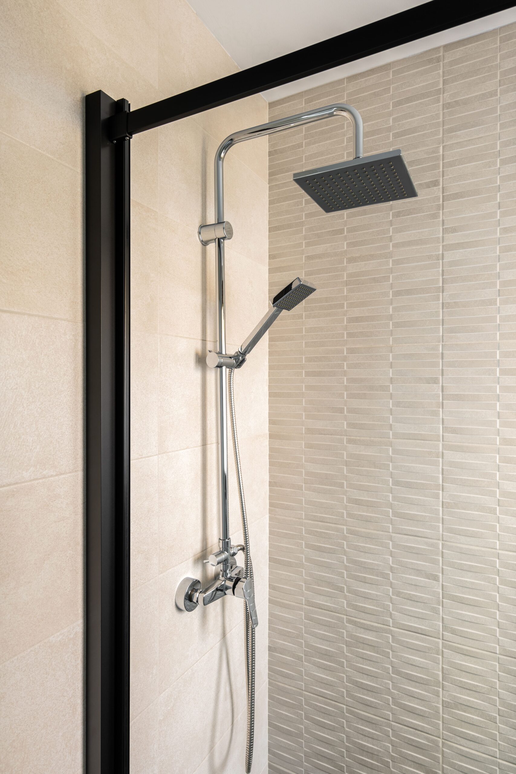 black-shower-ceramic-tiled-wall-vertical-view-modern-minimalist-interior-beige-color-min